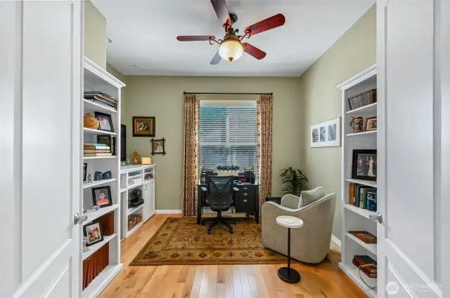 The den has double bookcases and built-in storage while still having plenty of room for a desk.