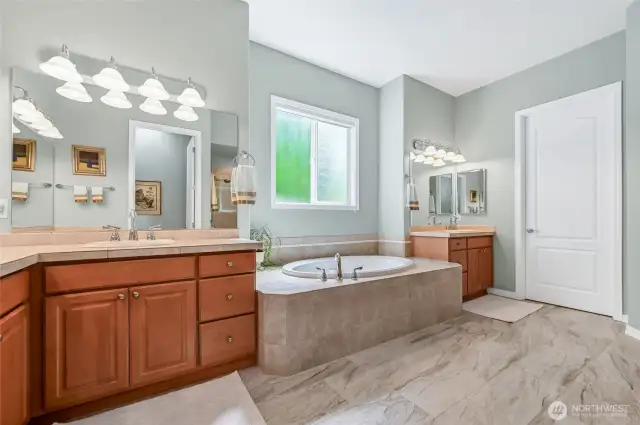 Through the door is the larger of the two walk-in closets and this one has been customized by Closets by Design.