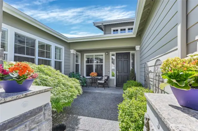 Gated courtyard entry with an aggregate patio space.