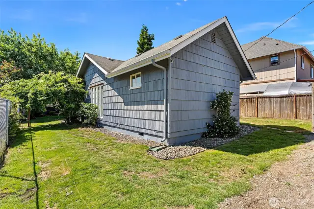 Enjoy the wisteria-filled arbor and lots of space to garden to your heart's content! (Back view of home)