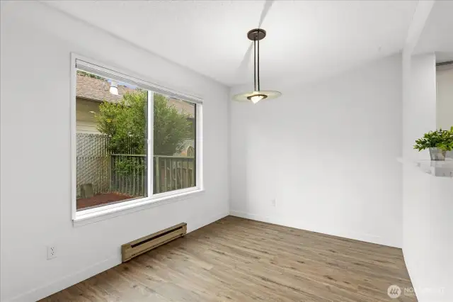 Dining area has large window view of back patio area.