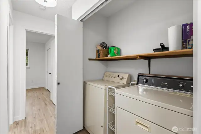 Laundry closet conveniently located in hall way.  Upper shelf could be added for extra storage!