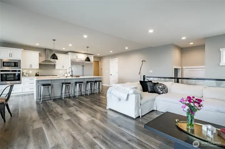 Led lighting, chef kitchen with hood, quartz countertops, long bar area, stainless appliances, pantry, good cabinet space and more