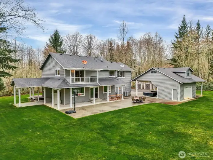 Back patio overlooking peaceful acreage.Detached workshop with storage loft above.
