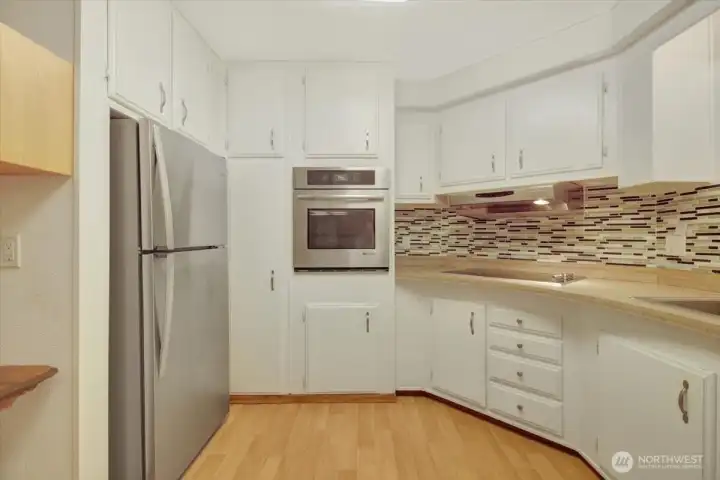 Stainless double oven, cooktop, and fridge
