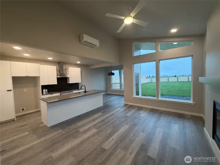 Living/kitchen with eating area in background & flooded with natural light