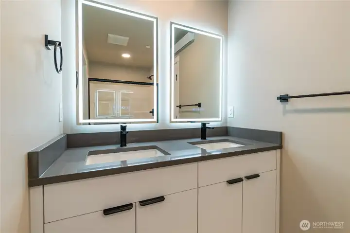 Primary ensuite with backlit mirror & double sinks