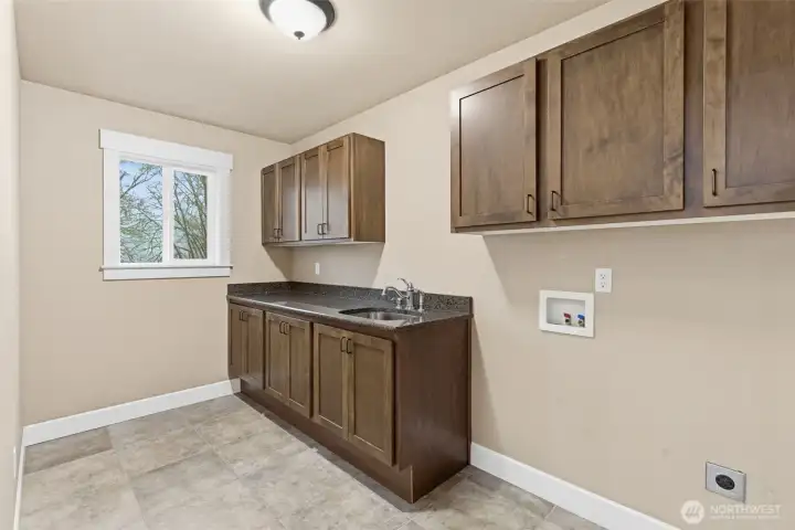 Upstairs laundry room, title floor, and granite counter tops!