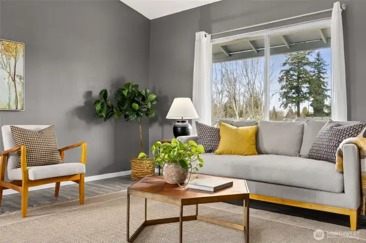 Large window offers abundant natural light and compliment the vaulted ceilings