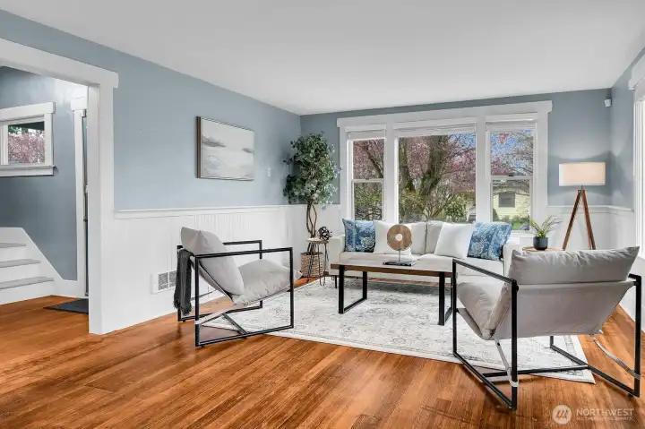 Original wood floors and bright white wainscoting are a showstopper!