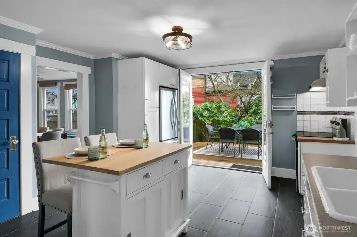 Convenient island with more storage, stainless appliances, and French doors that open onto the deck.