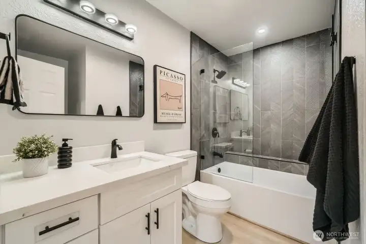 Spa-inspired bath with Tulum-style tile and frameless glass shower.
