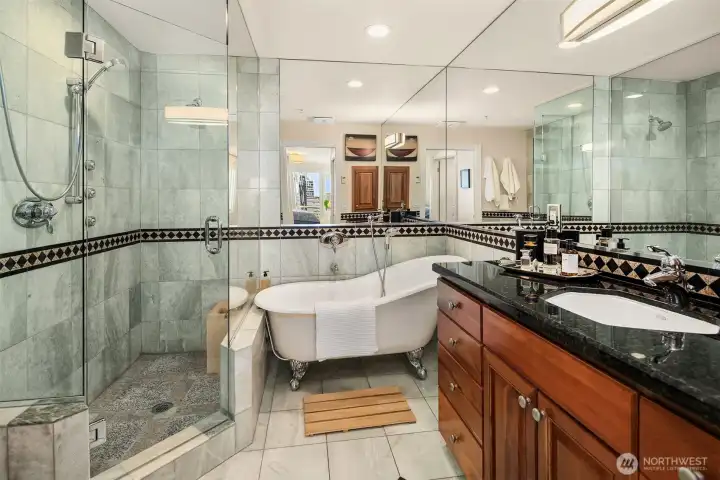 Spa-inspired bathroom features a clawfoot soaking tub and walk-in shower.