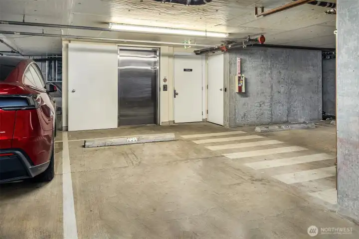 Secure garage parking space located beside elevator.