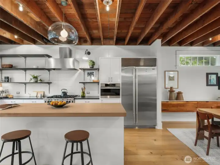 Premium stainless steel appliances including: Wolf 6-burner gas stove, Subzero refrigerator and wine cooler, Miele dishwasher and steamoven.