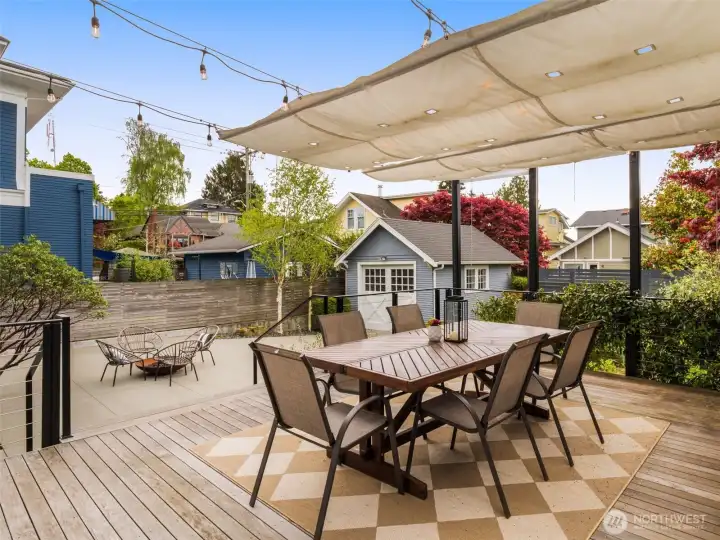 Deck made with ipei wood, custom sails and roller shades provide yaer around shade.