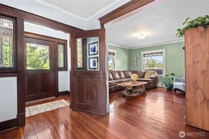 The formal front entry makes a lasting first impression with original doors, beautiful fir floors, and leaded glass windows that have welcomed guests for generations.