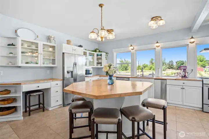 The kitchen's custom countertops were thoughtfully crafted from the maple tree that still stands near the front porch, transforming a piece of the property's history into a lasting centerpiece. A beloved landmark of the property, the tree was preserved when Bunker Creek Road was modernized, making the countertops a meaningful tribute to both the home's heritage and the generations who have cared for it.