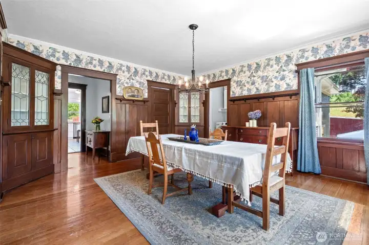 The jewel of the dining room is the original corner hutches with leaded glass doors, beautifully showcasing the craftsmanship of an earlier time. Rich wood trim surrounds this inviting space, offering plenty of room to gather everyone around the table. It's easy to see why it's owners' favorite room a place where meals, conversations, and memories come together.