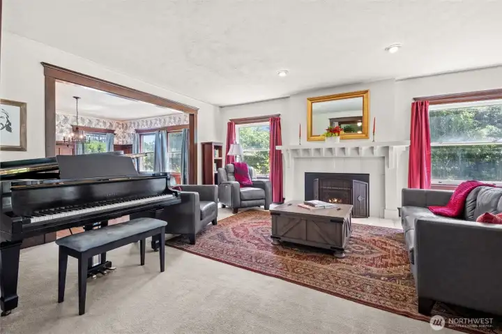 The living room is anchored by a fireplace and classic mantel, creating a warm gathering space and a beautiful showcase for treasured heirlooms, artwork, or seasonal decor.