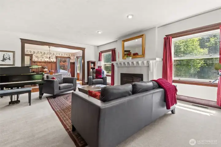Natural light flows into the living room through the original windows, illuminating the craftsmanship, warmth, and character that have welcomed generations through this remarkable home, while thoughtful updates provide the comfort and functionality appreciated today.