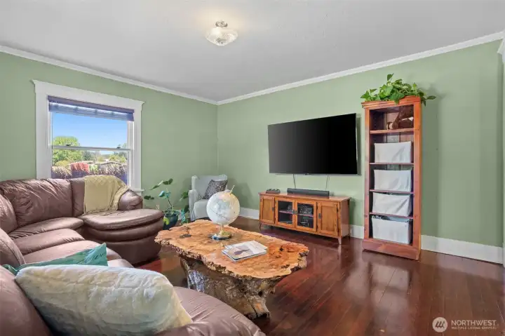 Once a place for conversation and entertaining, the parlor now serves as a welcoming TV room and den, continuing its tradition as a favorite gathering place within the home.