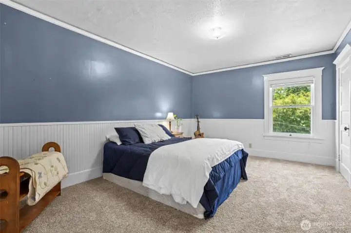 Bedroom 2 offers generous proportions and abundant natural light, creating a comfortable space for guests.