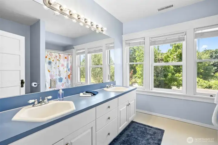 Thoughtfully renovated, the hall bath offers dual sink vanitie and a spacious oversized shower designed for everyday comfort.