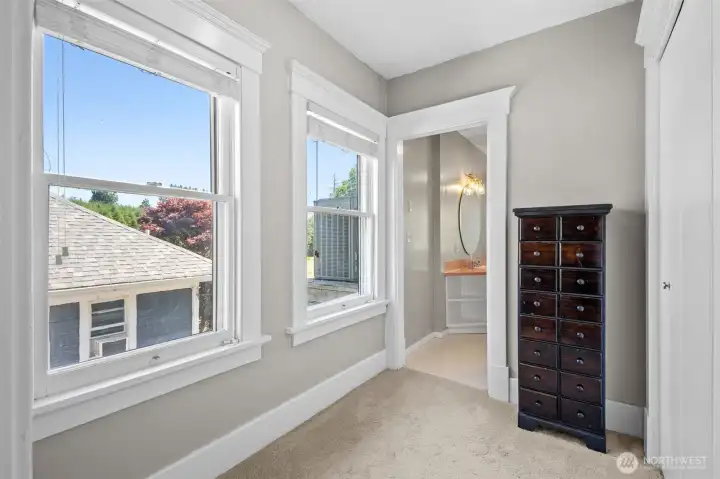 The dressing room in the primary suite connects the sleeping area and primary bath.