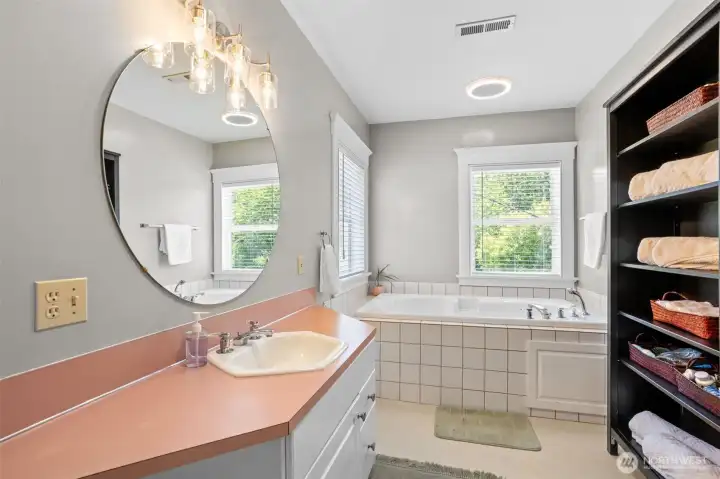 The spacious primary suite offers a peaceful retreat, complete with an attached bath featuring a large soaking tub an inviting place to relax at the end of the day.