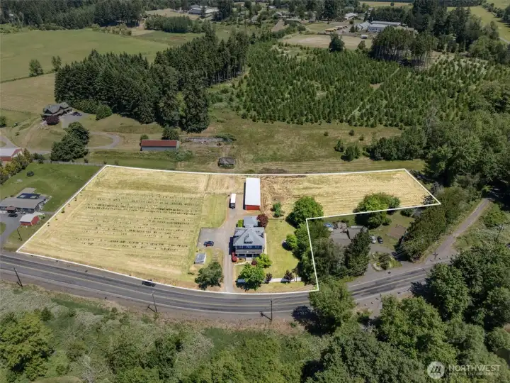 Bird's-eye view of the 4 acre property with approximate property lines outlined, showcasing the historic home, carriage house, blueberry field, pasture, and the beautiful setting that makes this property so special. Property lines are approximate and provided for reference only.
