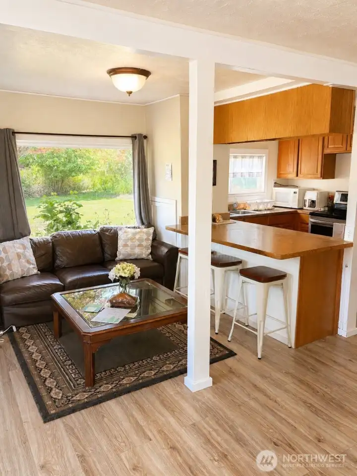 A cozy main living area provides the perfect gathering space within the carriage house, whether used for guests, family, or income potential.