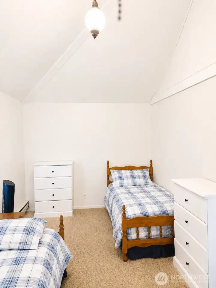 A comfortable bedroom completes the carriage house, offering privacy and convenience for a variety of living arrangements.