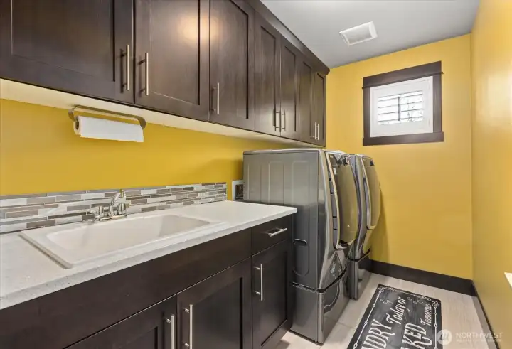 Well placed laundry room with sink! Located on the upper level where the bedrooms are! Genius!