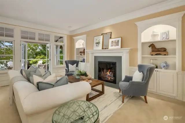 Fabulous entertaining size living room with gas fireplace, built-ins and French doors that open to the veranda that extends the width of the home.