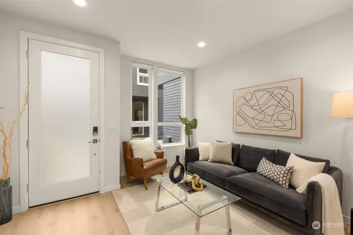 Photos of model home with similar finishes & floor plan. Natural light pours into this thoughtfully designed living space, highlighting modern finishes and warm wood flooring. The perfect balance of comfort and sophistication welcomes you the moment you walk through the door.