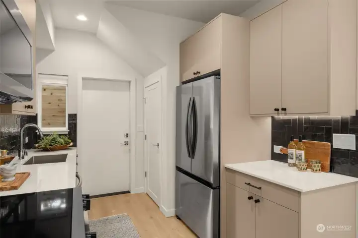 Photos of model home with similar finishes & floor plan. Designed with efficiency in mind, this kitchen maximizes every inch with sleek cabinetry, a full-size fridge, and additional counter space for prep and storage.