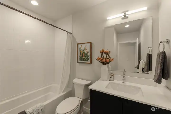 Photos of model home with similar finishes & floor plan. This thoughtfully designed bathroom features sleek finishes, a full tub, and ample counter space—perfect for your morning routine or an evening soak.
