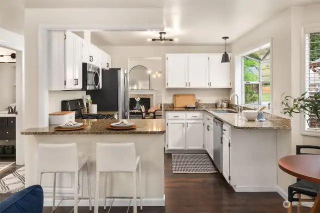 kitchen is in the middle of the living room and the family room area.  Easy access and great sight line to everything.