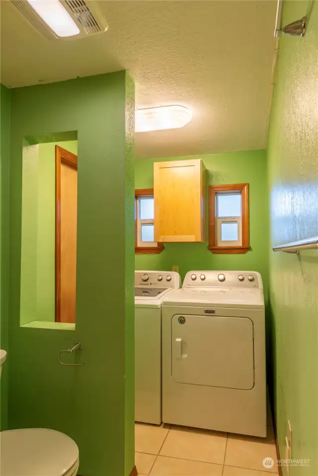 Washer and dryer are at the back of the primary bathroom. Washer and dryer stay with home.