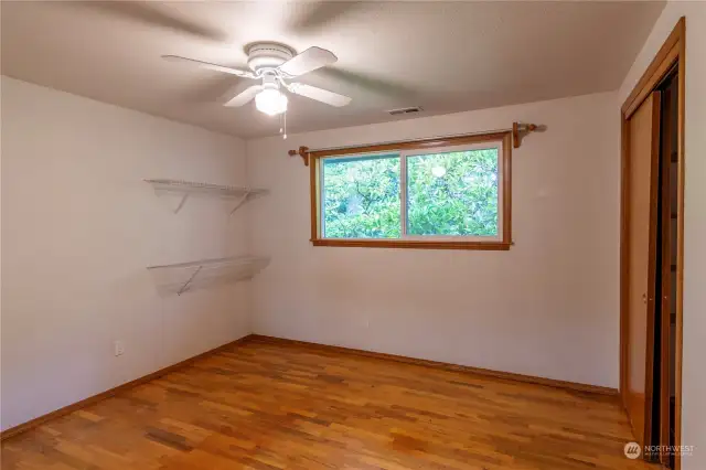 One the three bedrooms with hardwood floors. All bedrooms have fans with lights.