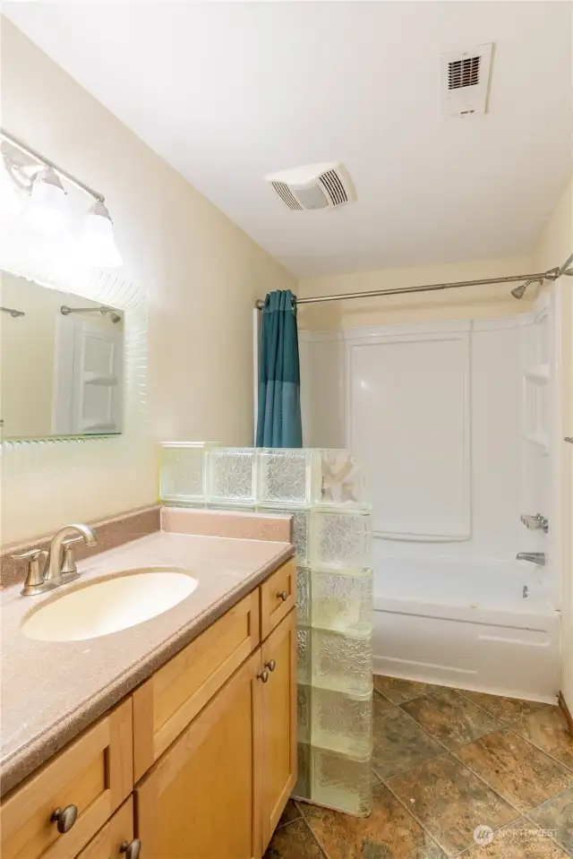 Guest bathroom off hallway with access for guests and bedrooms off the hallway.