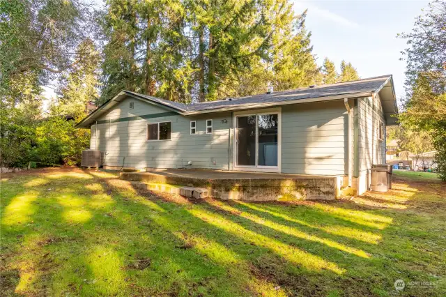 Back of home with patio area and private back yard.