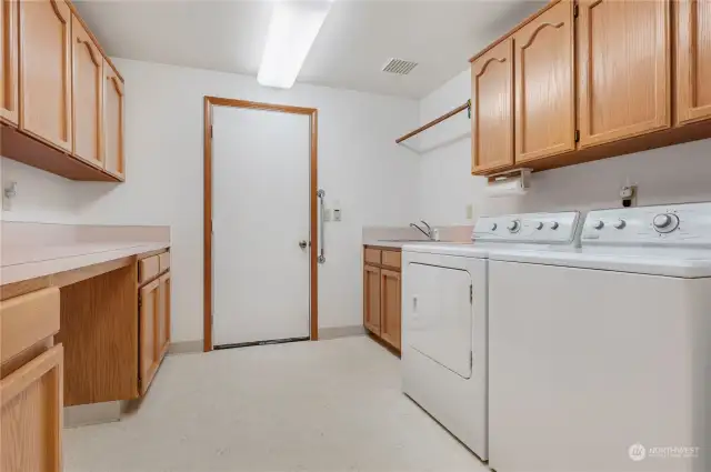 Laundry room with sink, extra storage and folding counters