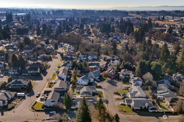 South facing Aerial shows hills in distance: Portland’s West Hills and Forest Park Hiking Trail areas