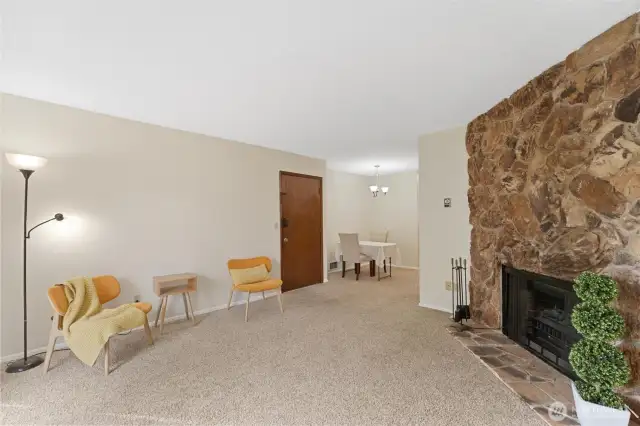 Come on in! Floor to ceiling river rock accent wall wraps the wood fireplace, currently with an electric fireplace insert for convenience.