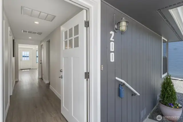 Looking through the entry hall to the door opening to the patio beach side.