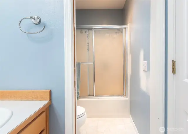 Hall bathroom with dividing door for privacy.