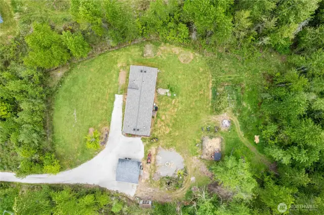 The trail system entrance is to the right of the backyard. Room for exploring, riding dirt bikes, or even hunting in your own backyard.