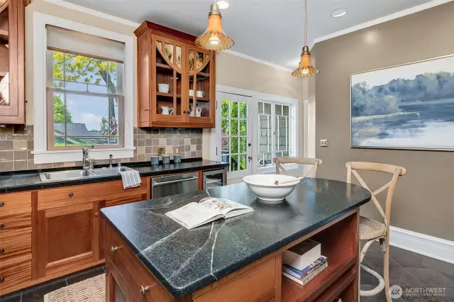 Off the kitchen, a walk-in pantry includes shelving, a washer-dryer, a second refrigerator, and a powder room.